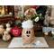 A Christmas elf decoration made from a dried gourd. This gourd, named Pip, has a happy face carved into it and is wearing his won elf hat
